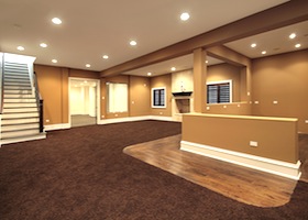 Lower level basement in earth tones and marble fireplace